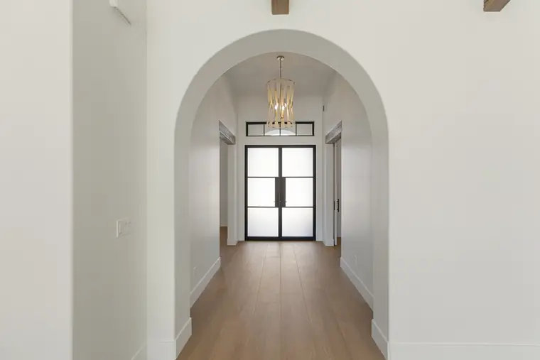 Arched hallway looking toward the front doors