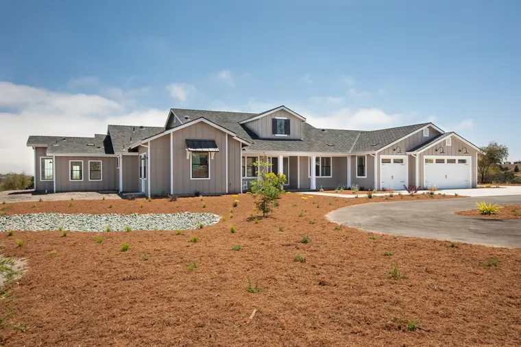 Single-story home with a wide front porch and three-car garage