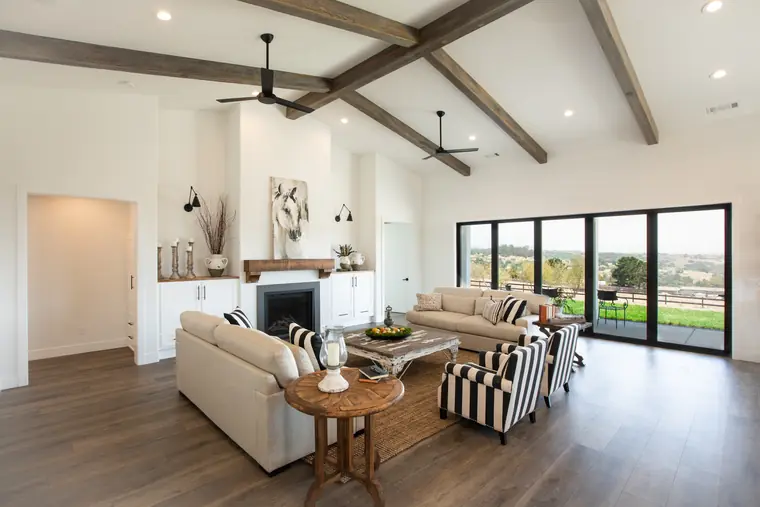 Living area with a fireplace and a wall of glass doors