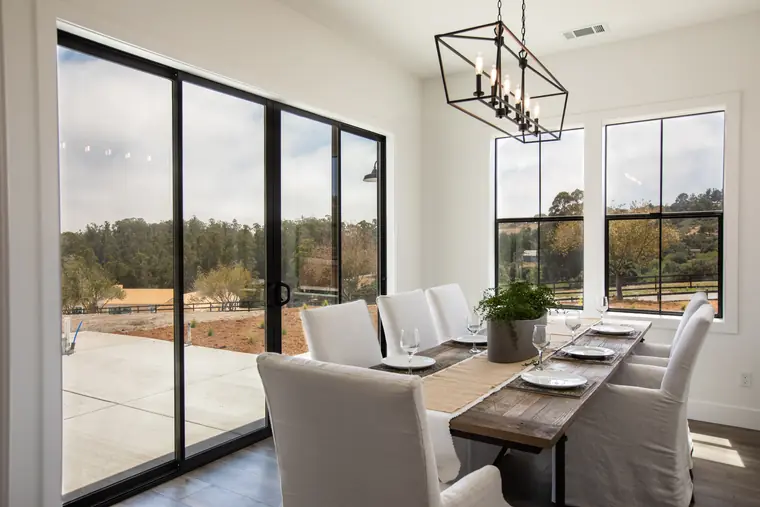 Dining area with sliding glass doors and a lantern chandelier