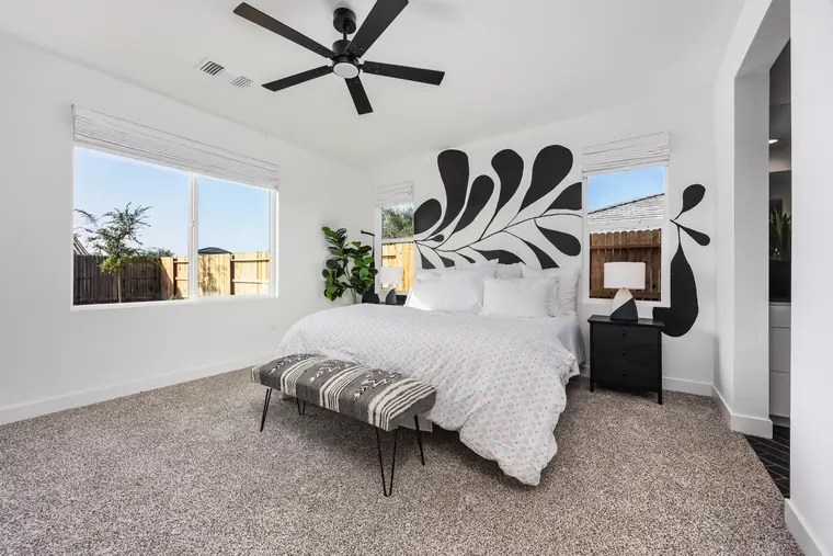 Primary bedroom with a black-and-white mural wall