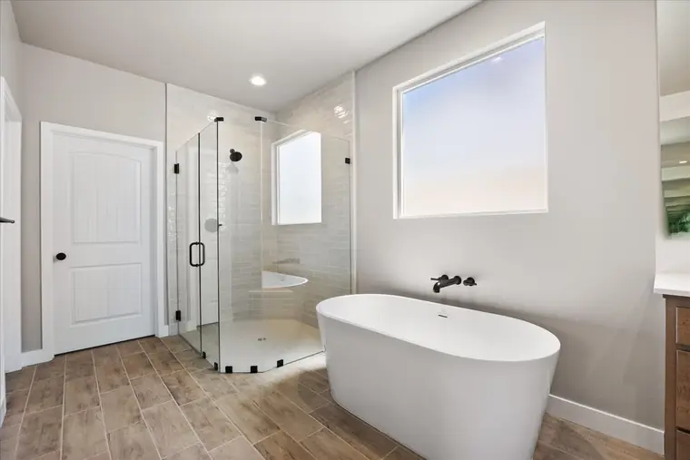 Primary bath with a freestanding tub and glass walk-in shower