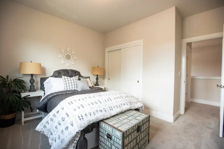 Primary bedroom with a sitting bench and double closet