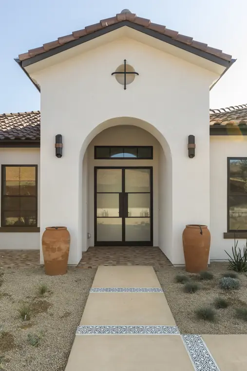 Arched entry with steel-and-glass double doors