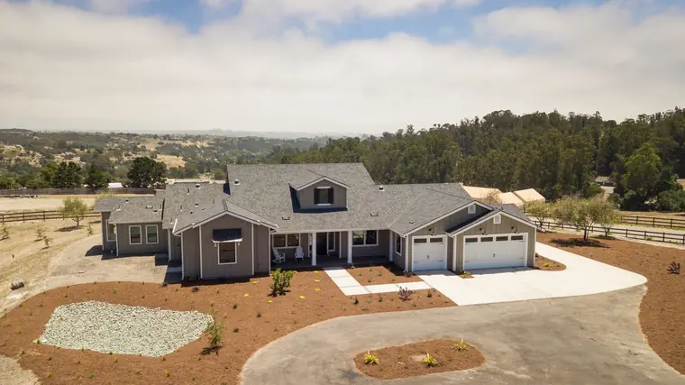 Aerial view of a single-story home with a circular drive