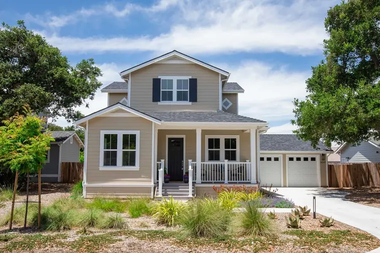 Farmhouse-style home with a front porch and white trim