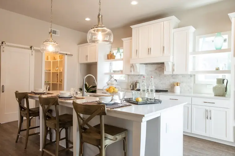 Open kitchen with island seating and glass pendant lights