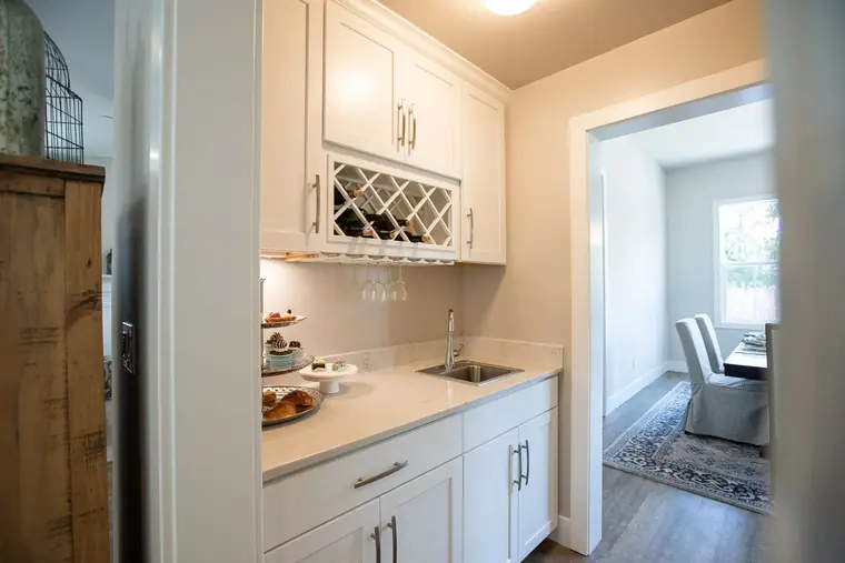 Butler's pantry with a wine rack and glass-front cabinets