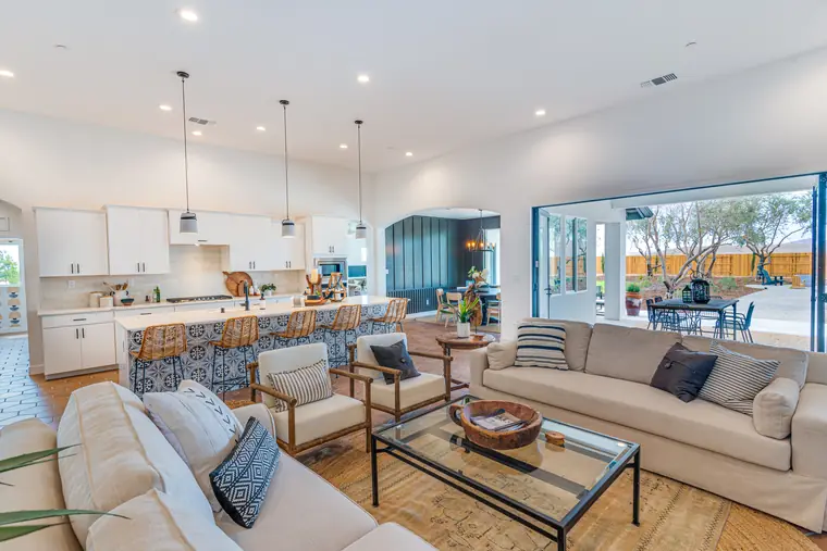 Great room with sectional seating, open to the kitchen and patio