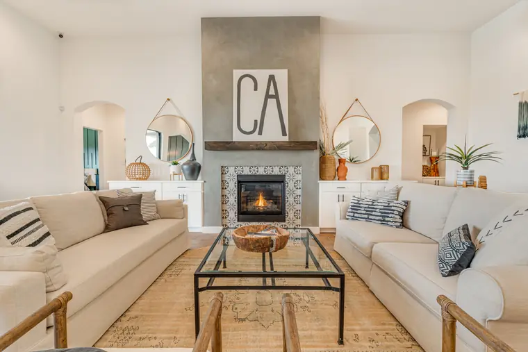 Family room fireplace with a tile surround and arched niches