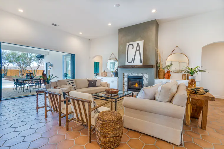 Family room with hexagon tile floors and a fireplace, open to the patio