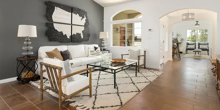 Living room with a gray accent wall and arched openings