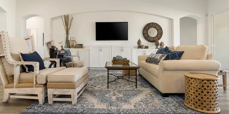 Living room with built-in cabinets and blue accents