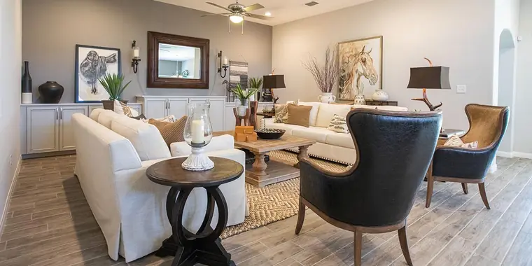 Living room with white sofas and leather chairs