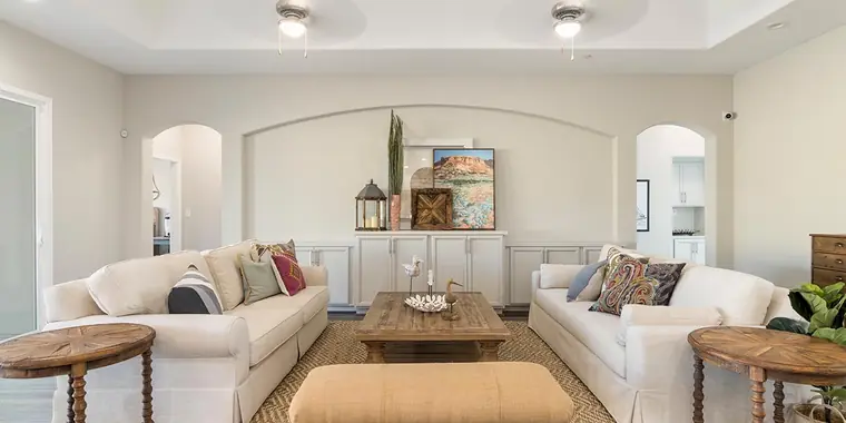 Living room with white sofas and an arched wall niche