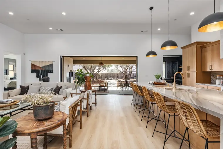 Open great room flowing into the kitchen and patio