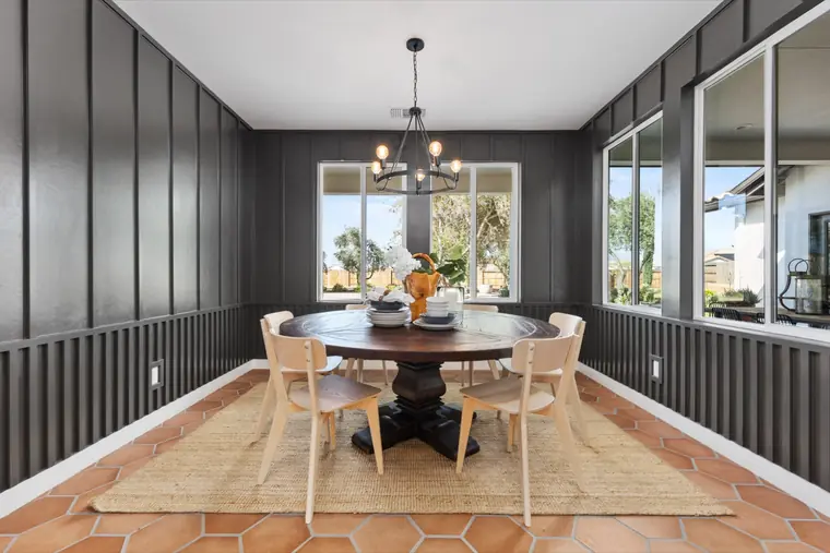 Dining room with black board-and-batten walls and a round table
