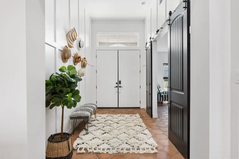 Entry hall with double front doors and a black barn door