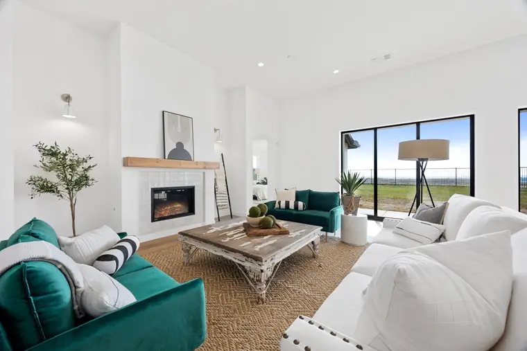 Living room with a fireplace and emerald velvet sofa