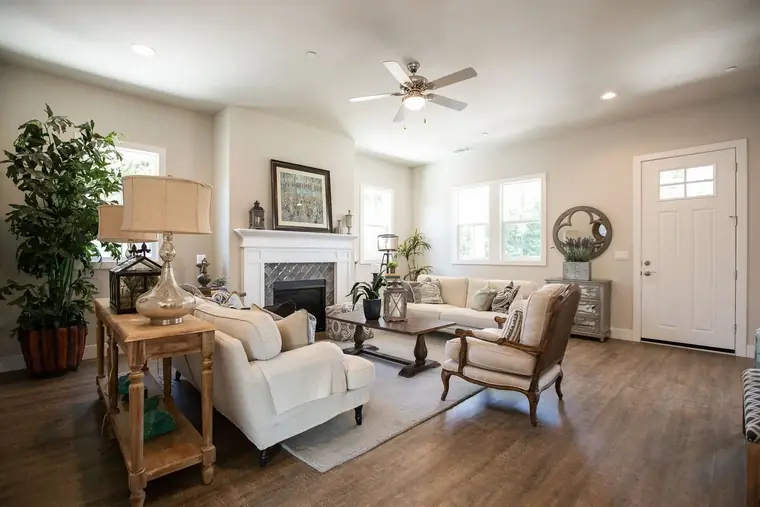 Living room with a fireplace and white slipcovered sofas