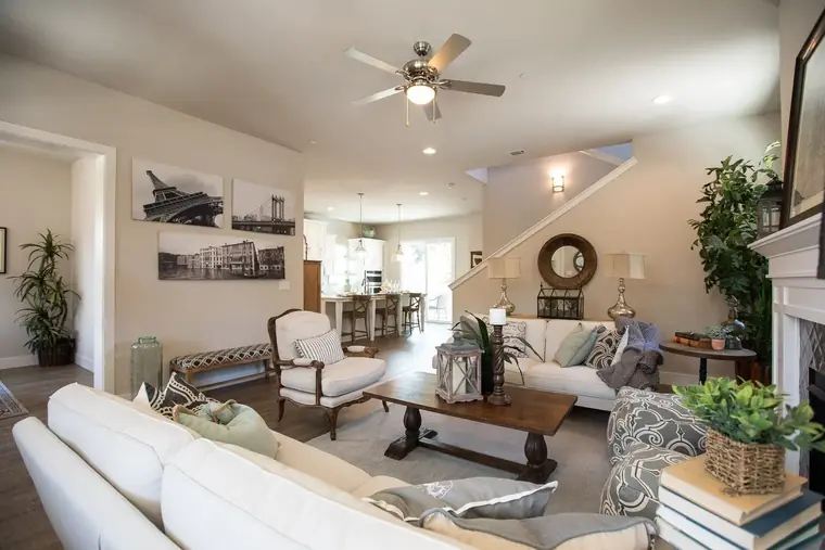 Living room seating area with a fireplace and ceiling fan