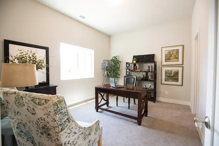 Home office with a desk and framed art