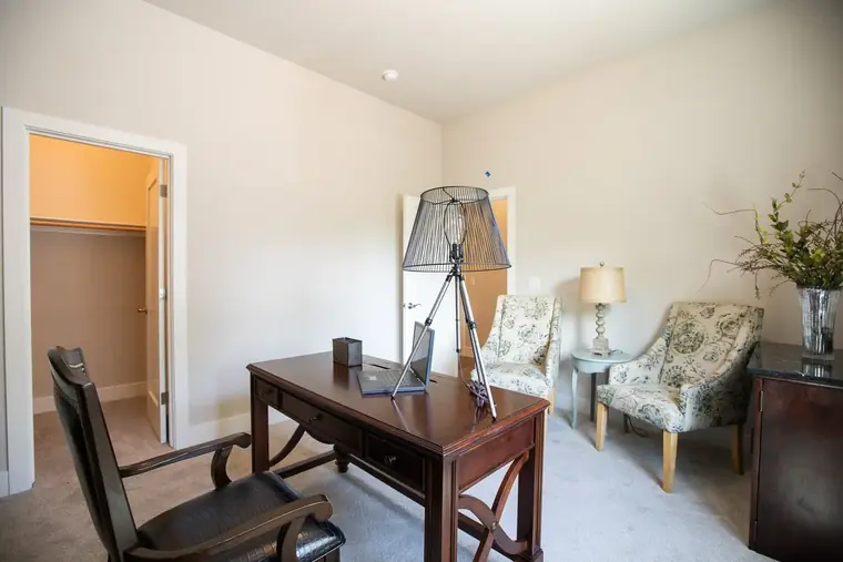 Study with a writing desk and armchairs