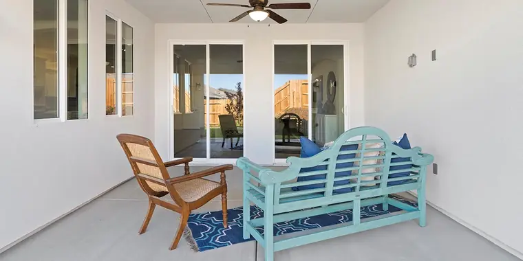 Covered patio with a bench and chairs