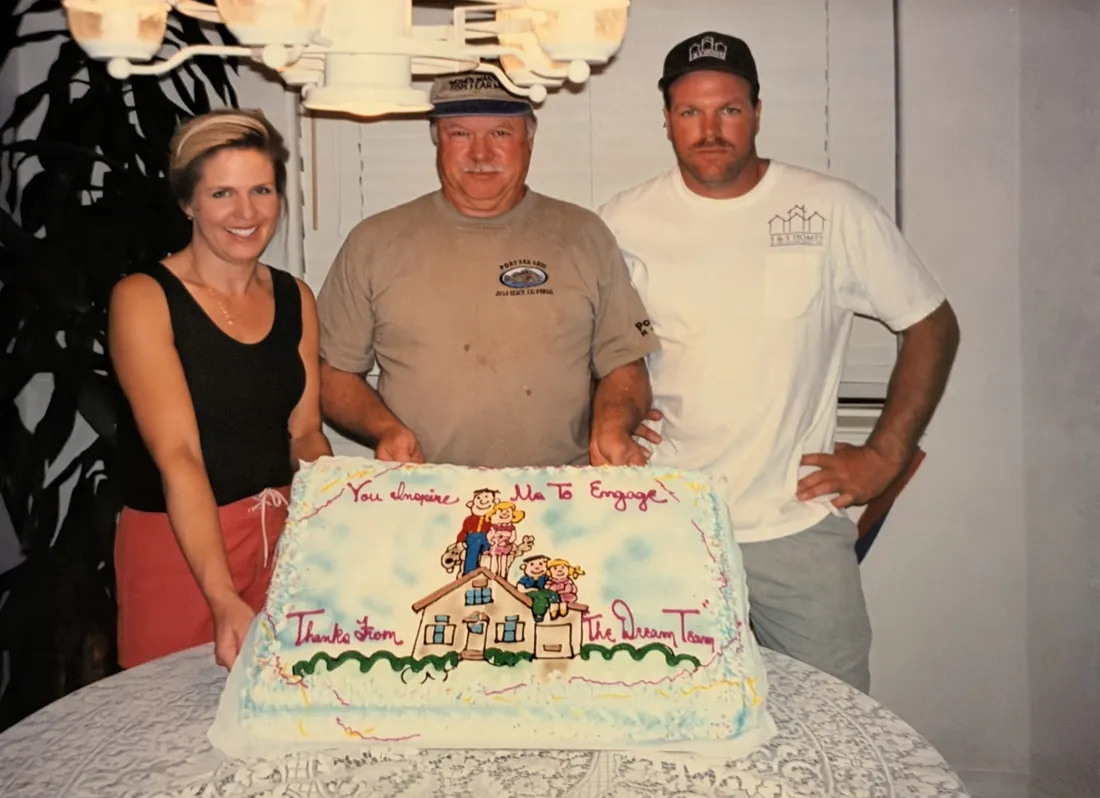 Janet Axelsen, Warren Sanders, and Steve Sanders behind a sheet cake that reads Thanks from the Dream Team